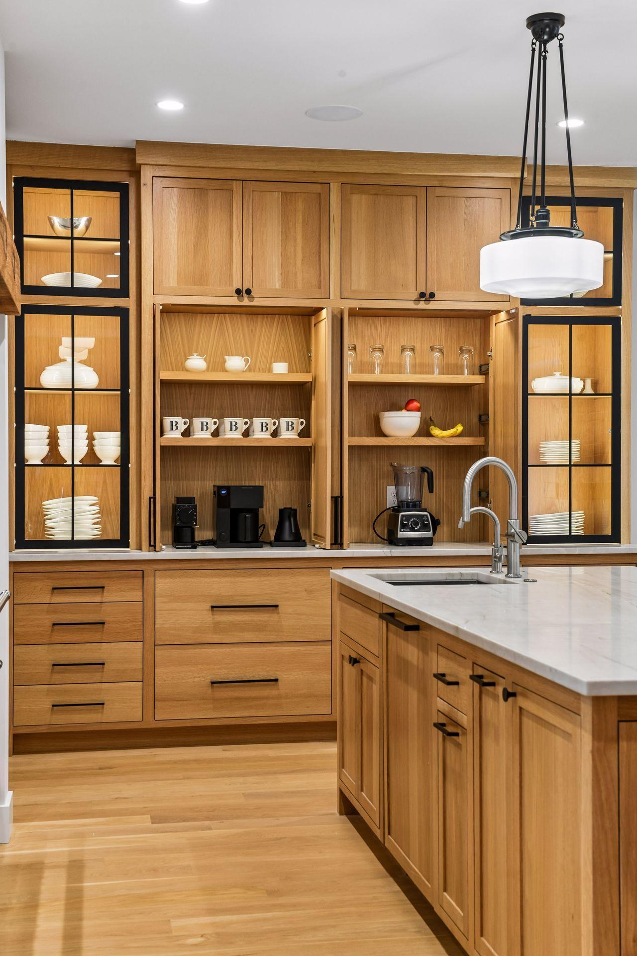 Doors slide to the back of the cabinets when making coffee or smoothies but can be closed to conceal appliances when not in use.