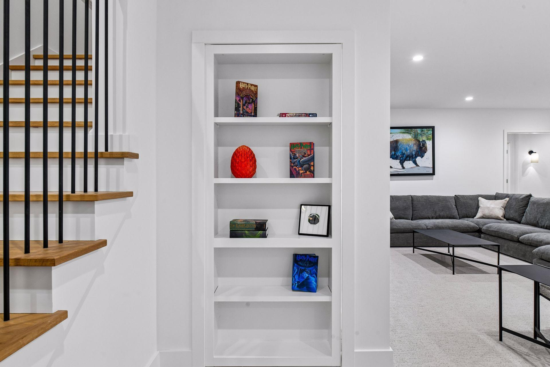 A bookshelf conceals a secret place for children to play.