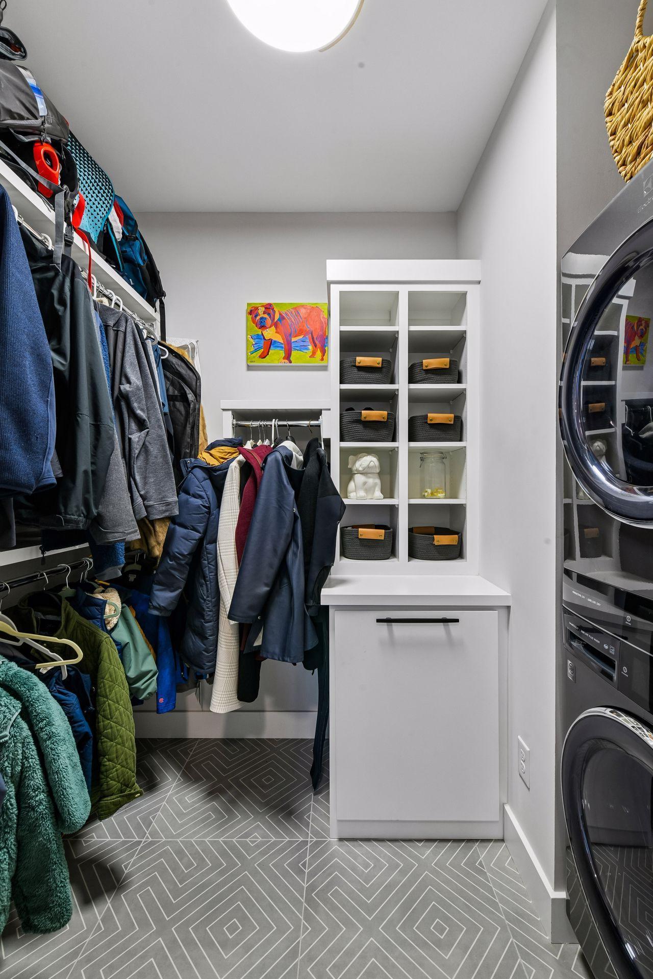 Custom cabinetry by Century Cabinets keeps coats and sports equiptment out of sight. A first floor stackable laundry keeps workout and sports clothes clean.
