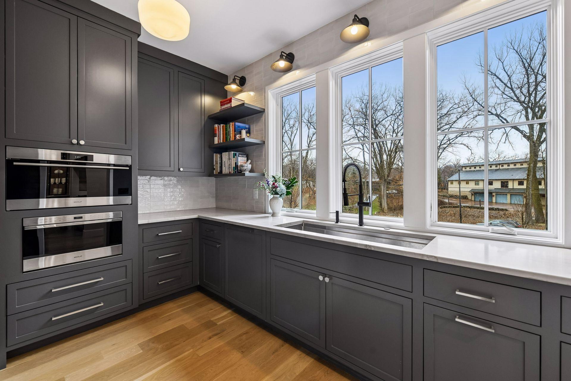 The back kitchen houses the large partitioned work sink, dishwasher, microwave and steam oven. Floor to ceiling cabinets abound for more storage.