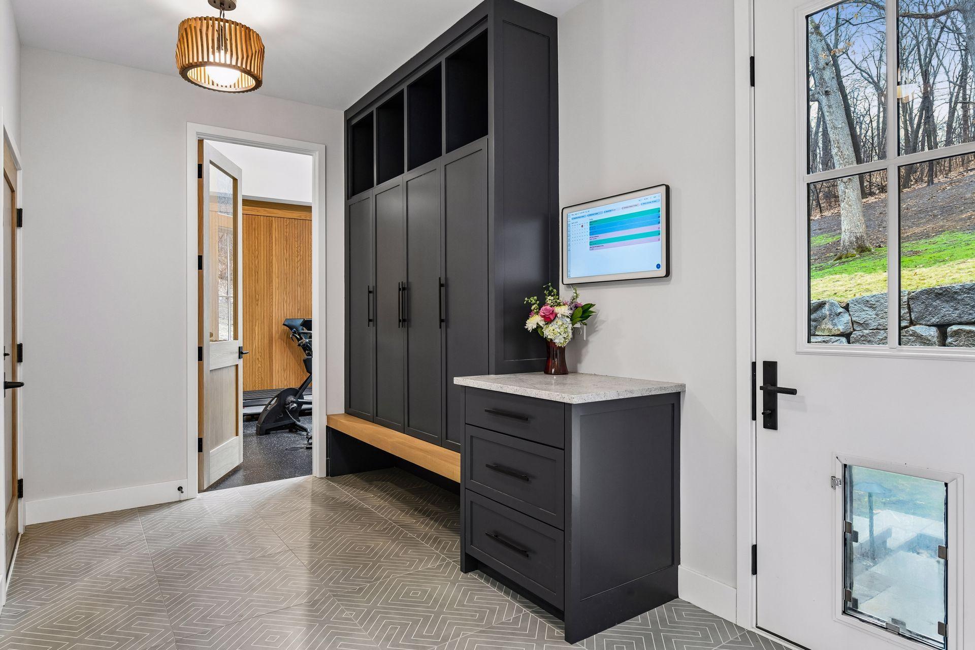 Custom mudroom cabinetry keeps family members organized and hides clutter.