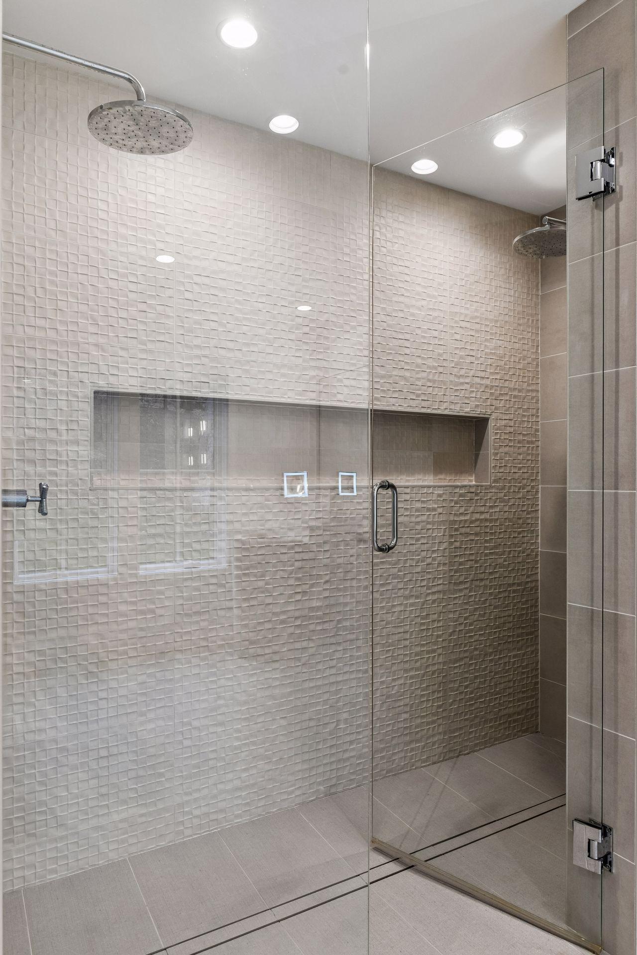 Double rain showers and large inset shower shelf keep this primary bath spa like.