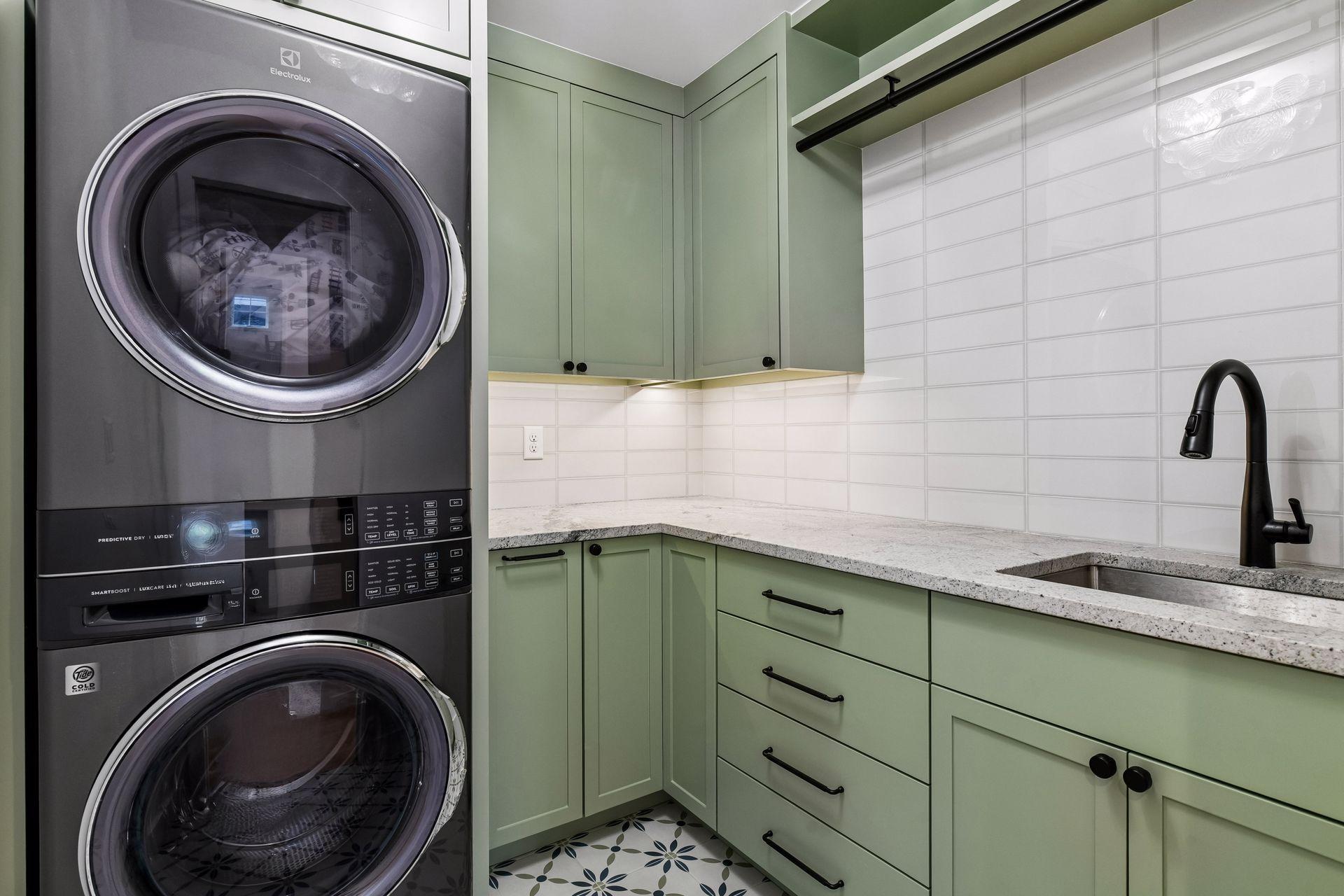 A second stacked laundry set on the second floor with custom cabinets built to keep a family organized.