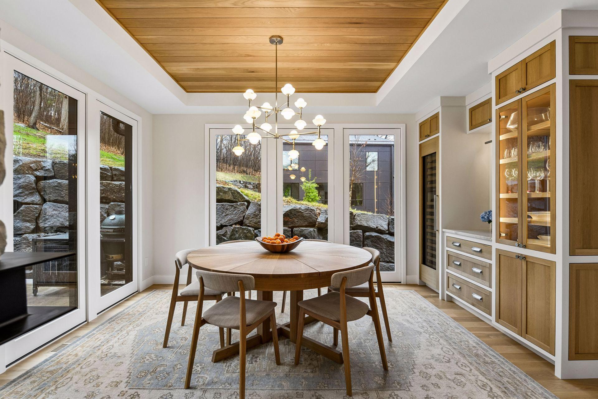 This dimmable custom chandelier within this separate dining space makes dinner parties feel both lively and intimate.