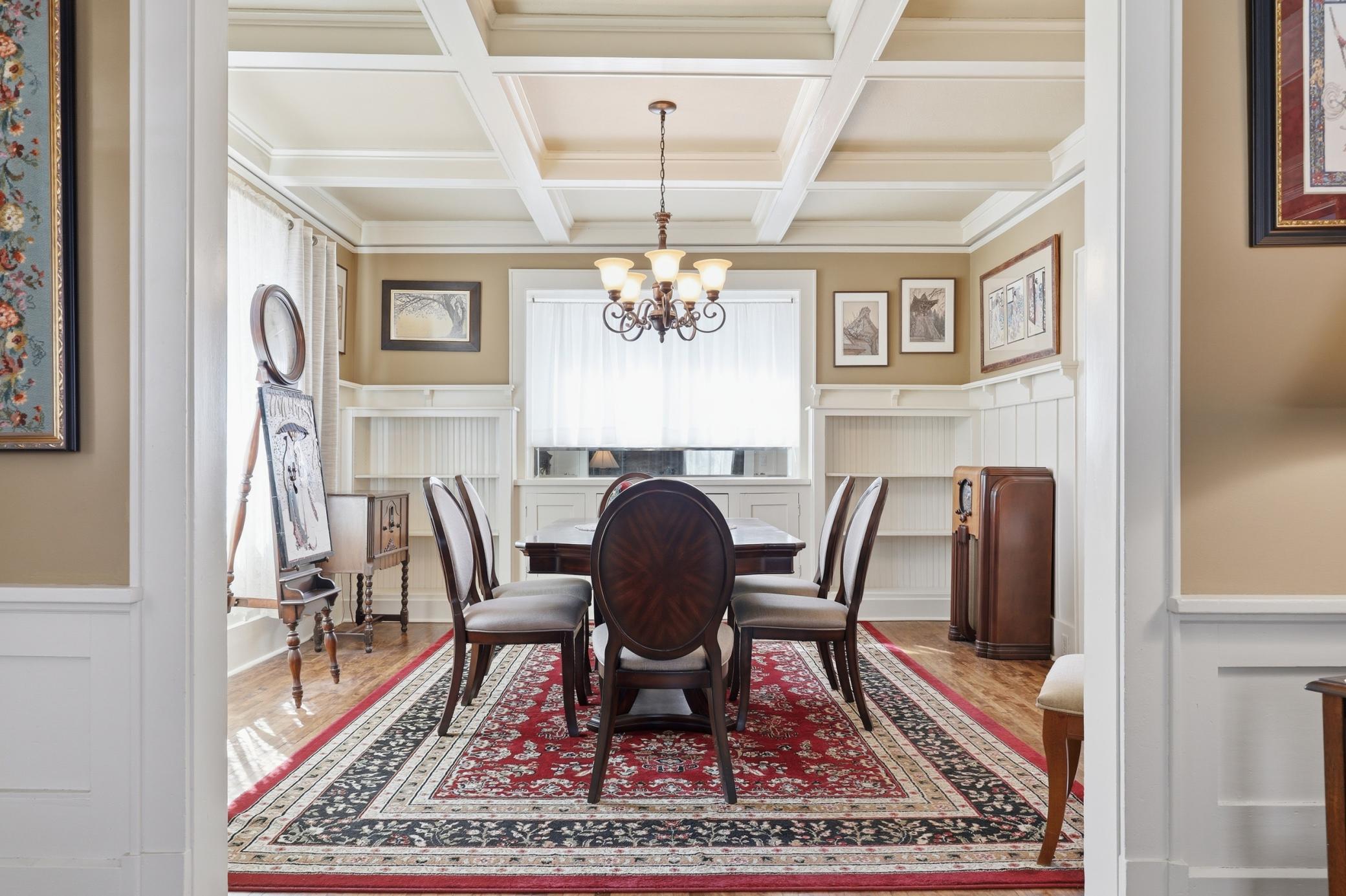 Dining room area with the original built-ins, coffered ceilings, and refurbished hardwood floors.