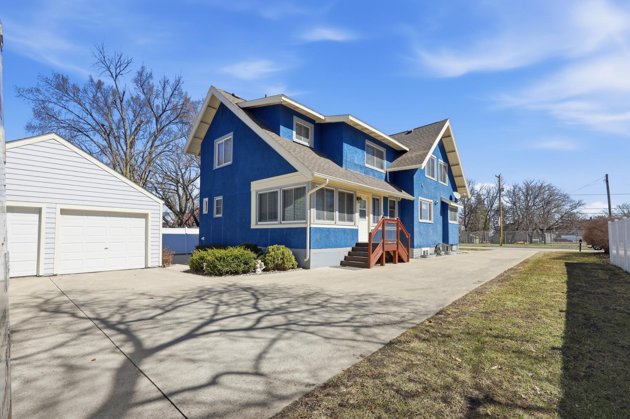 View of the home, concrete driveway, and garage.