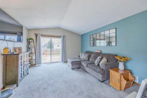 Large, bright living room leading you to the deck.