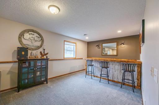 Family room wraps around to bar area. Bar not included in sale of home. Bring your vision!