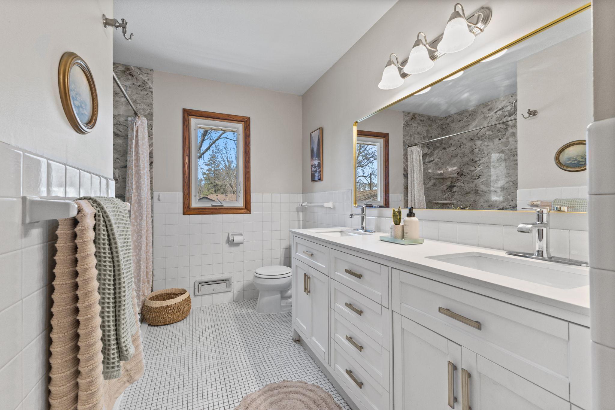 Well-appointed bathroom with dual vanity and clean, modern finishes