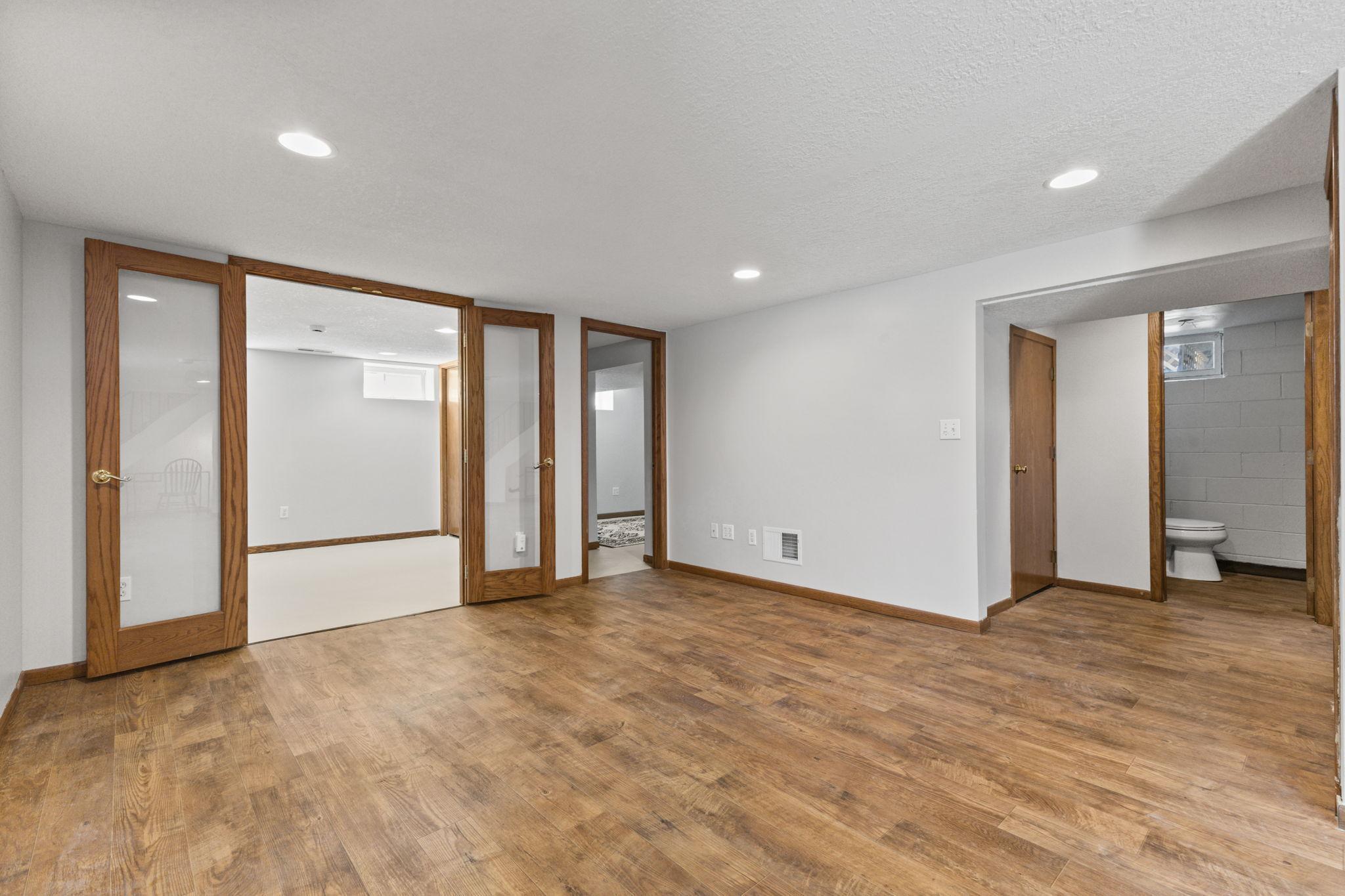 Finished lower level area with flexible use for entertainment, office, or guest space.