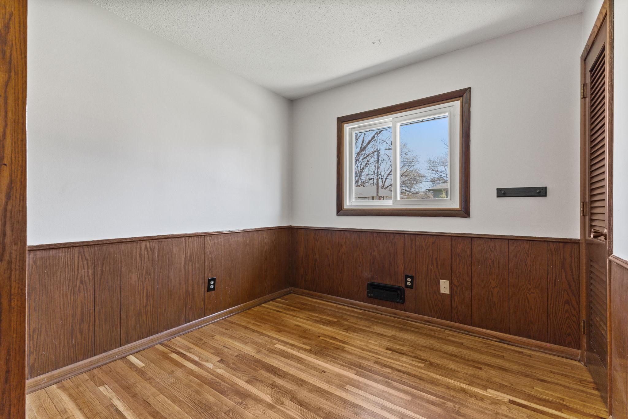 Versatile room with wood accents and plenty of natural light—ideal for office, bedroom, or hobby space