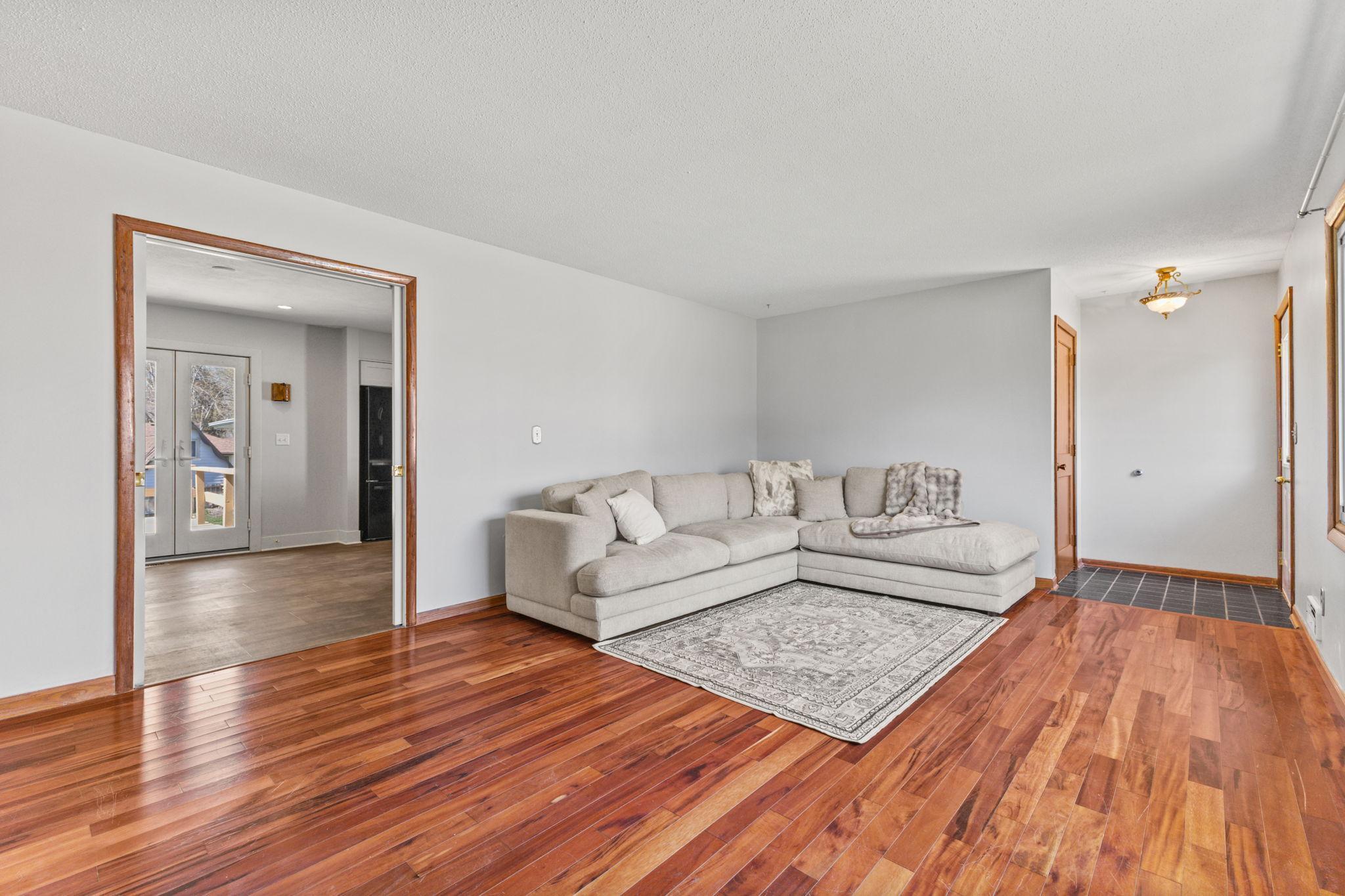 Spacious living area with warm hardwood floors and open layout