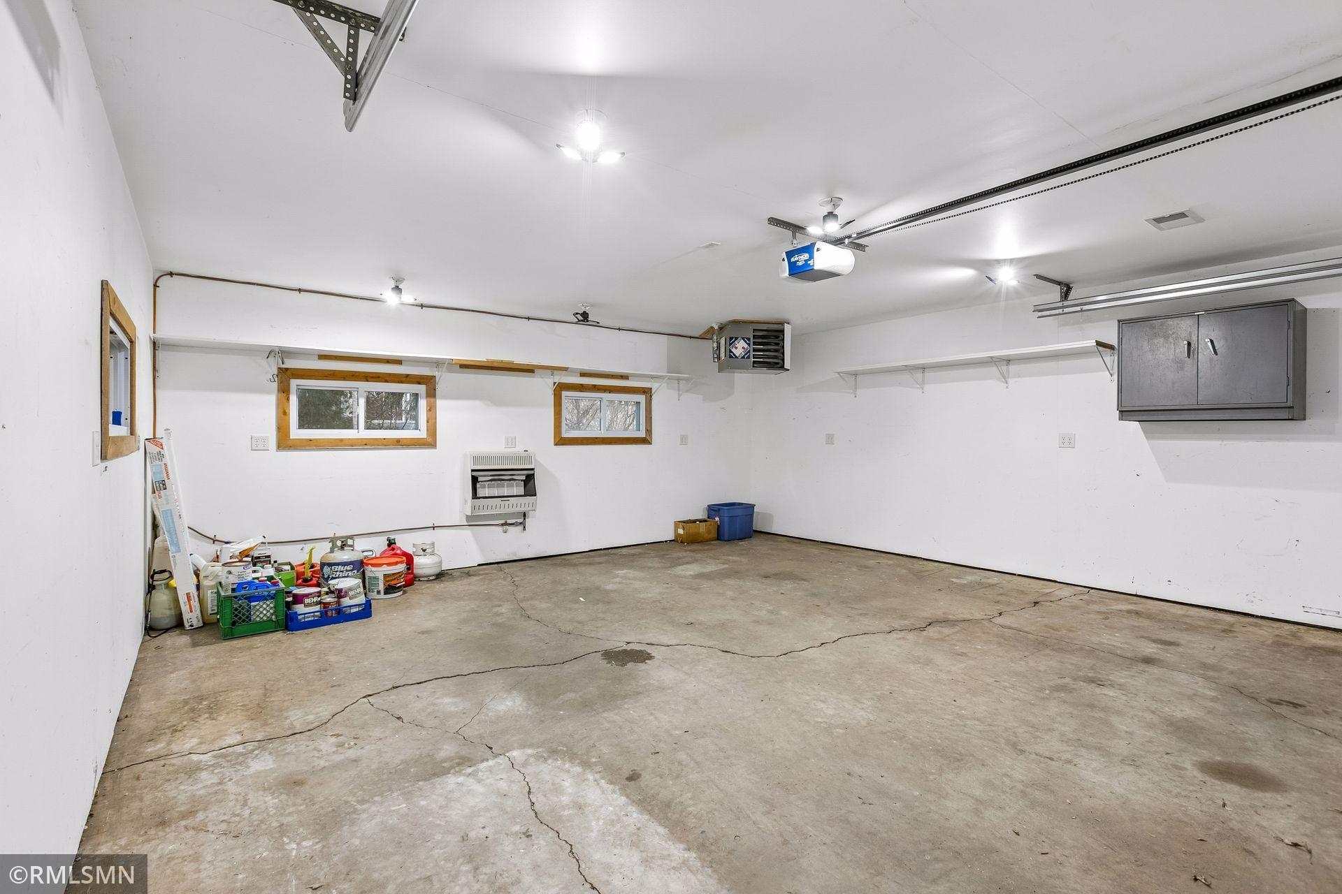 Clean garage w/finished walls, ceiling & heater