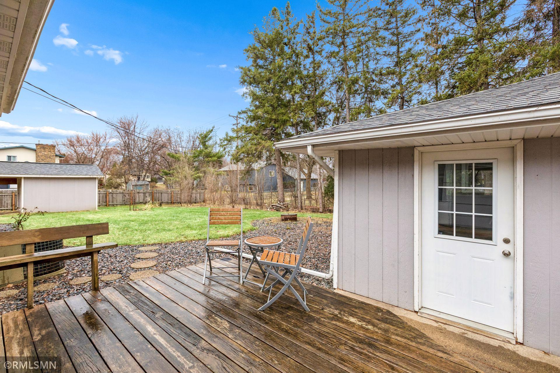 Deck off of kitchen overlooking backyard