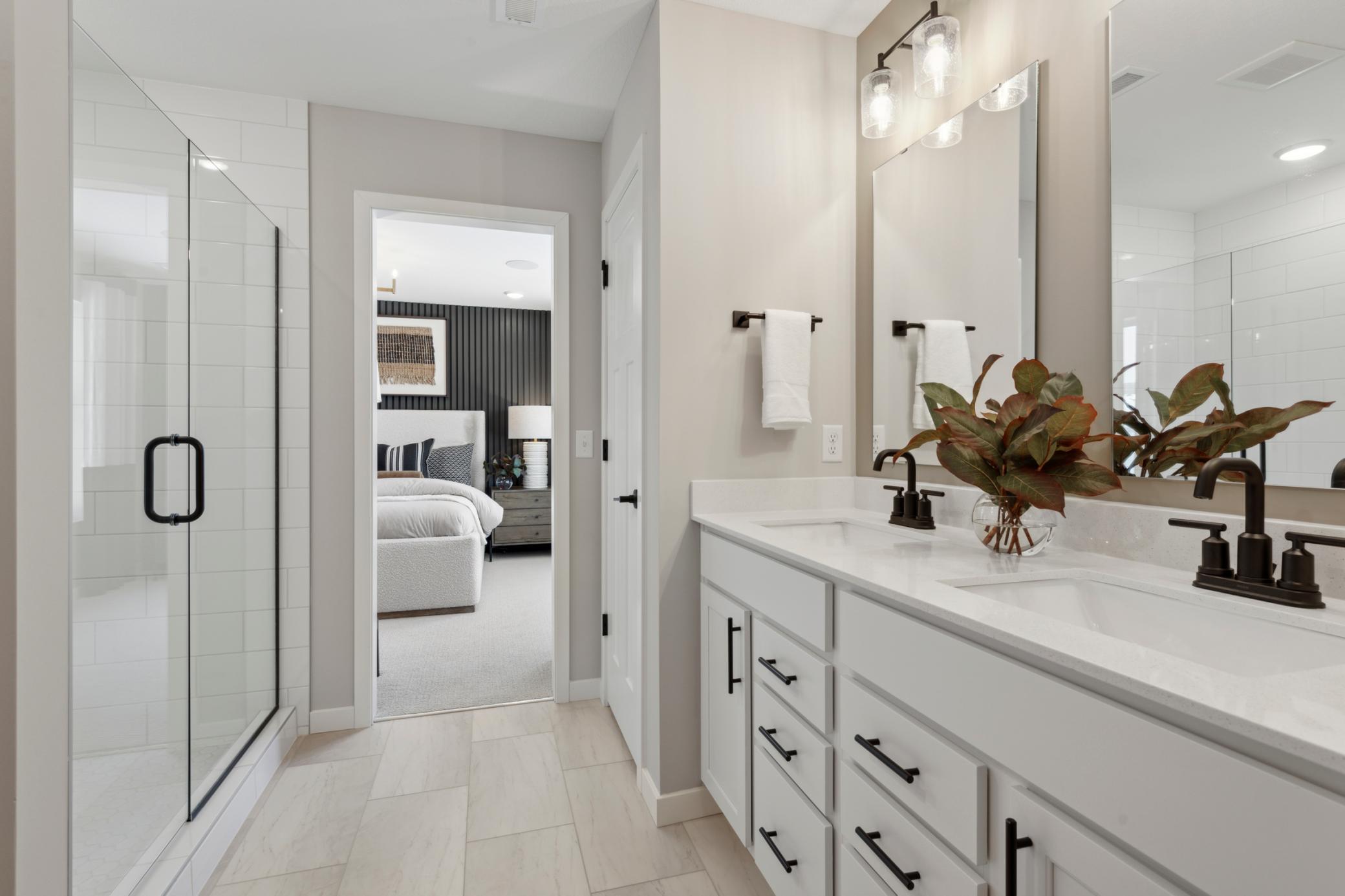 Thoughtful lighting and large mirrors enhance the space, creating a bright, polished atmosphere perfect for everyday routines.jpg