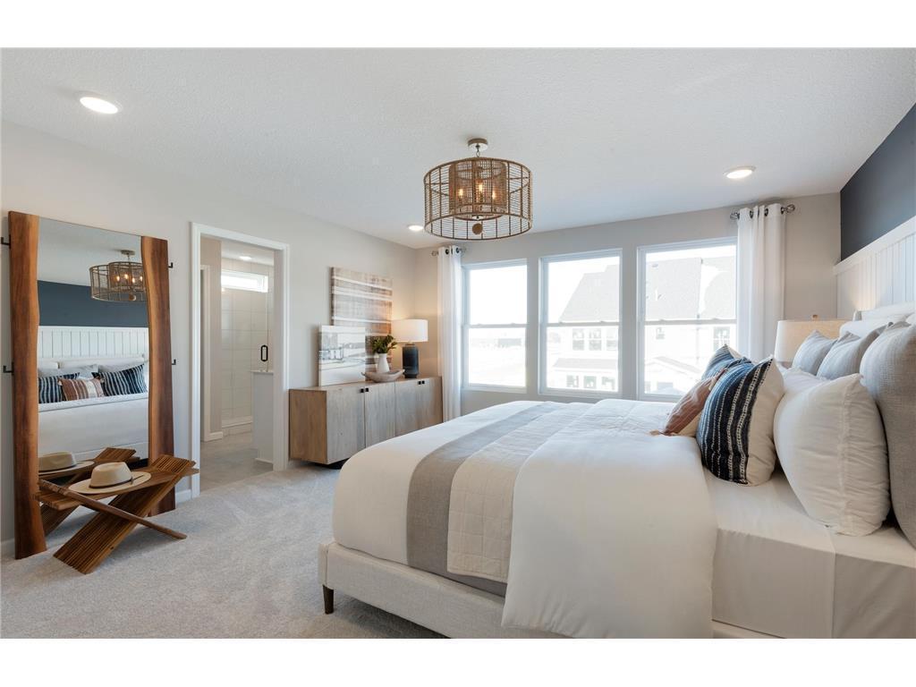 Huge windows and ample space make the Ashton Primary Bedroom one to remember! Photo of model home.