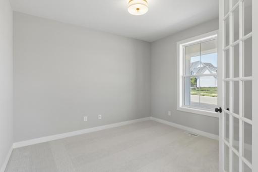 Large flex room at entrance of home makes for a great office (photo of actual listing).