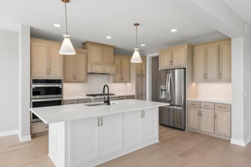 Kitchen features large center island with cabinets on both front & back of island (photo of actual listing).