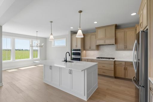 Kitchen in open to spacious dining area(photo of actual listing) .