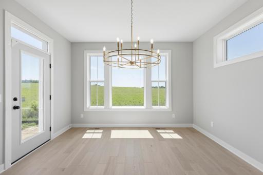Bright & sunny dinette with windows on three walls for a four season porch feel (photo of actual listing).