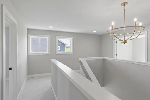 Large landing at top of stairs features windows and room for desk and /or bookshelves (photo of actual listing).