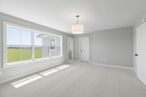 Spacious primary suite complete with dramatic double doors, private bath and walk-in closet (photo of actual listing).