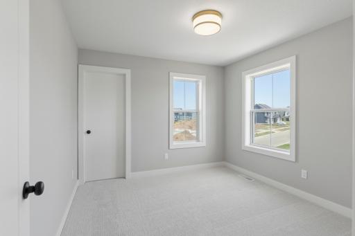 One of four bedrooms includes windows on two different walls (photo of actual listing).