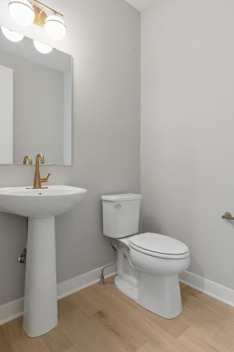 Main floor powder room with graceful pedestal sink (photo of actual listing).