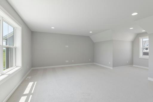 Spacious bonus room above three car garage features windows on both the front and back for maximum light (photo of actual listing).