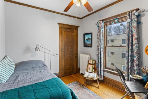 One of the bedrooms with ceiling fan & sunny south facing view.