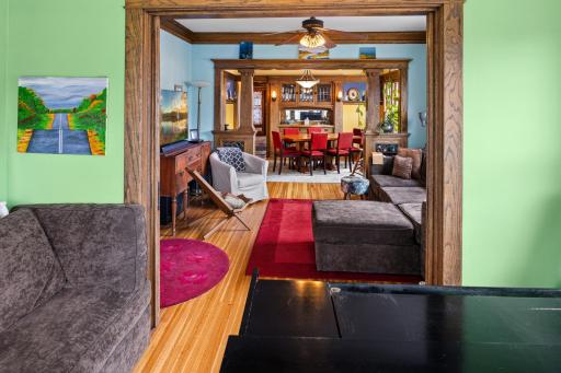 View from sunroom toward living/dining areas. Don't miss the stunning windowed pocket doors tucked into that archway!