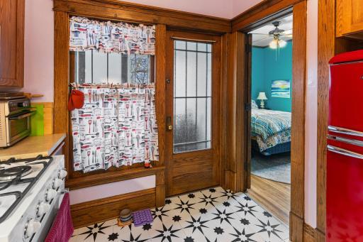 Looking from kitchen into bedroom #2 and back door to common back stairway.