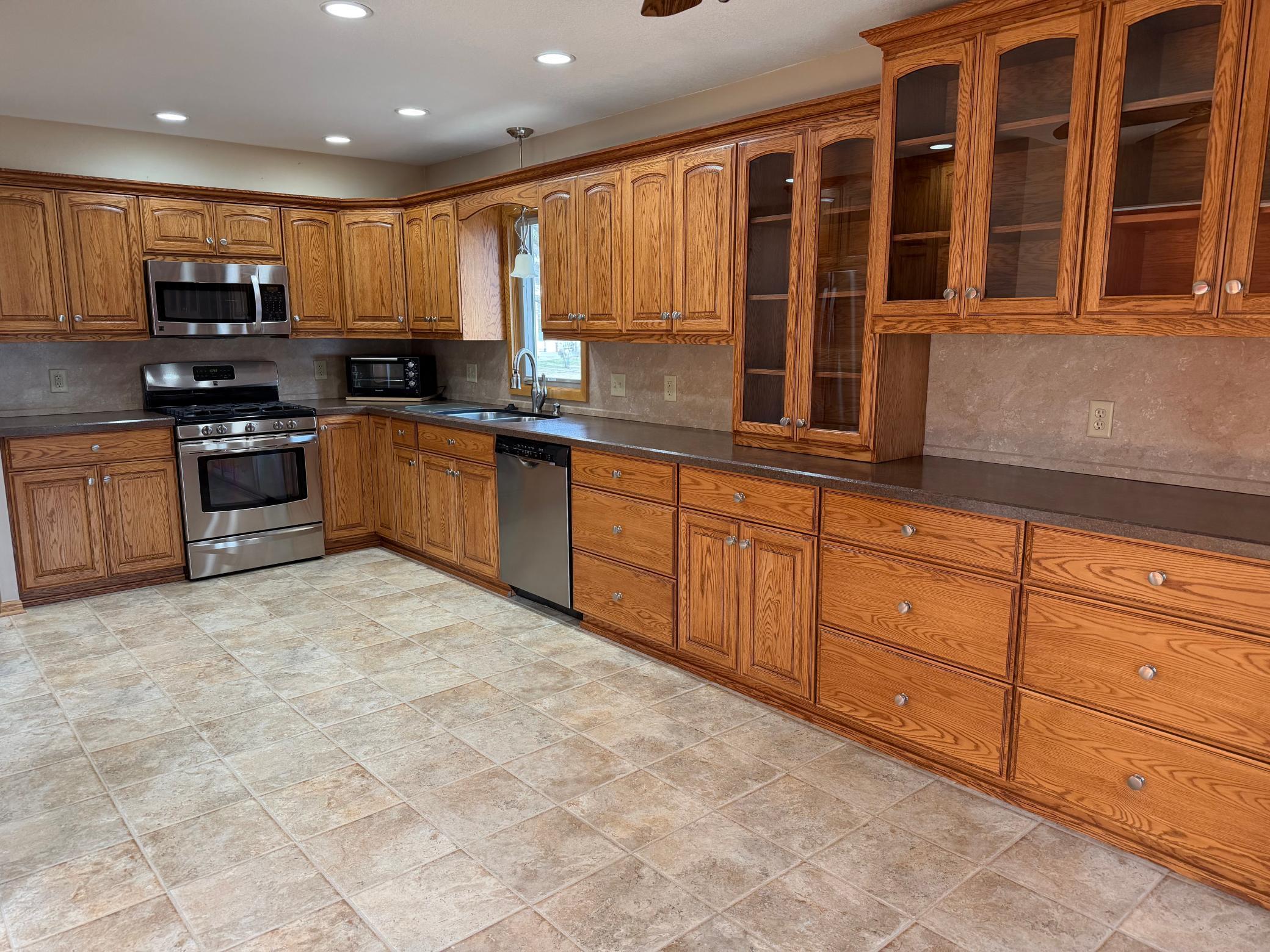 Huge kitchen with loads of cabinets and countertops.