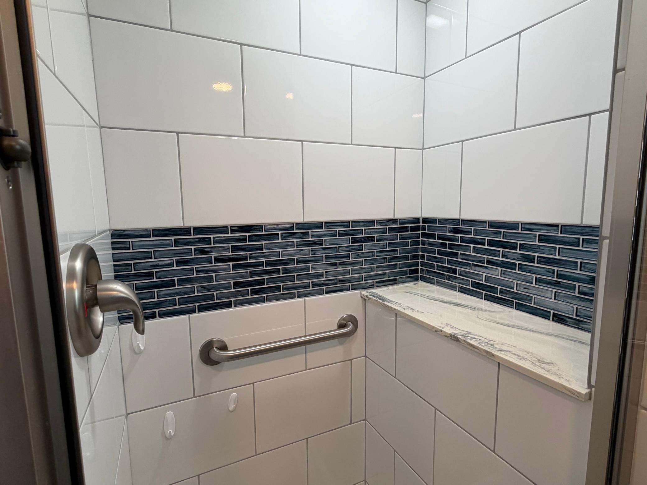 Shower has a large ledge for holding your products.