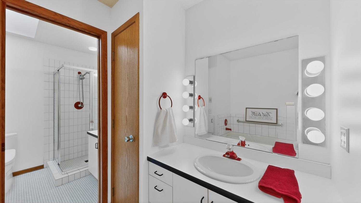 Primary bath, 2 separate sinks, pocket door between shower/tub area