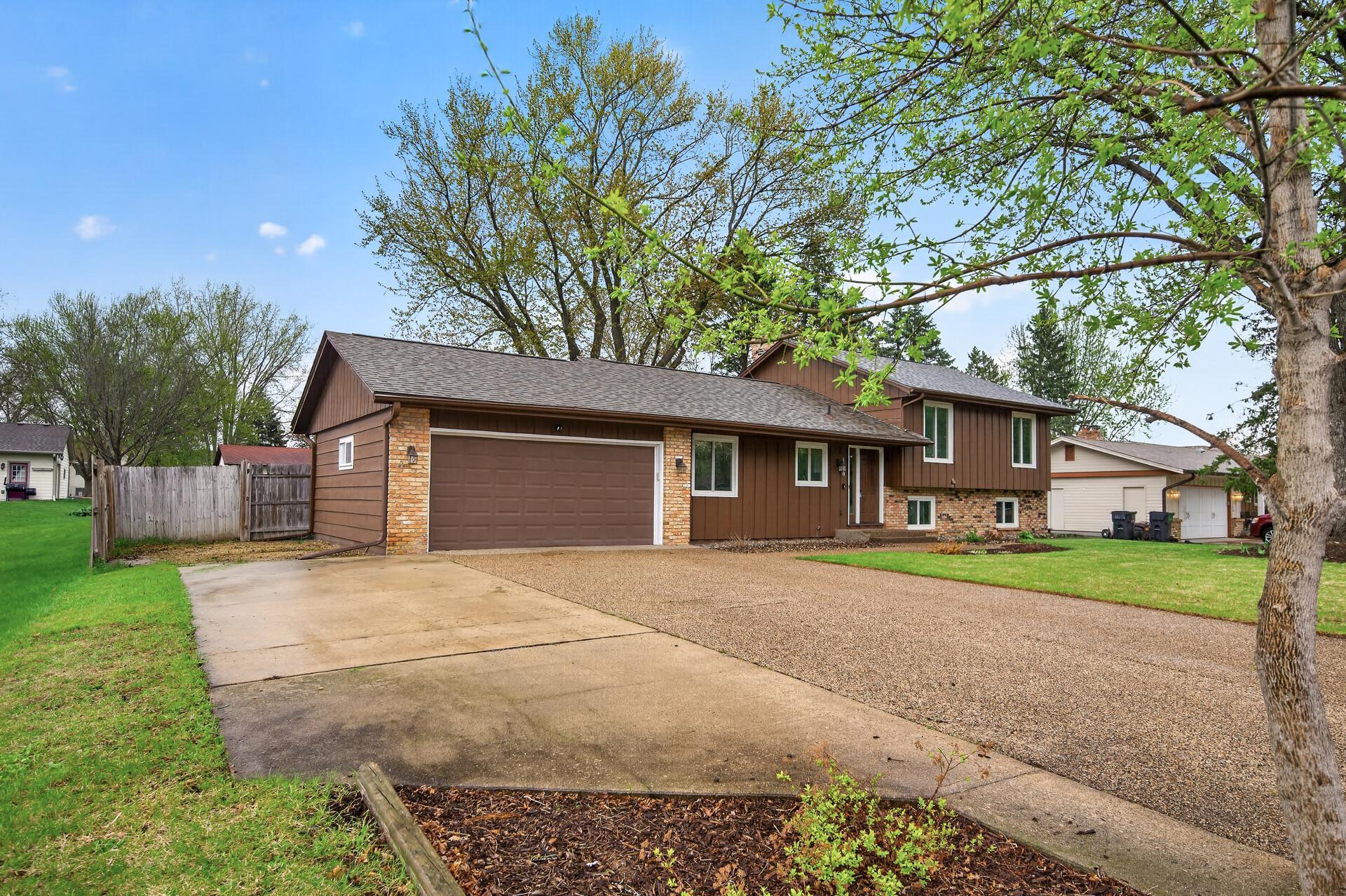 The insulated and heated 2-car garage includes a concrete parking pad with room for additional vehicles, a boat, or an RV