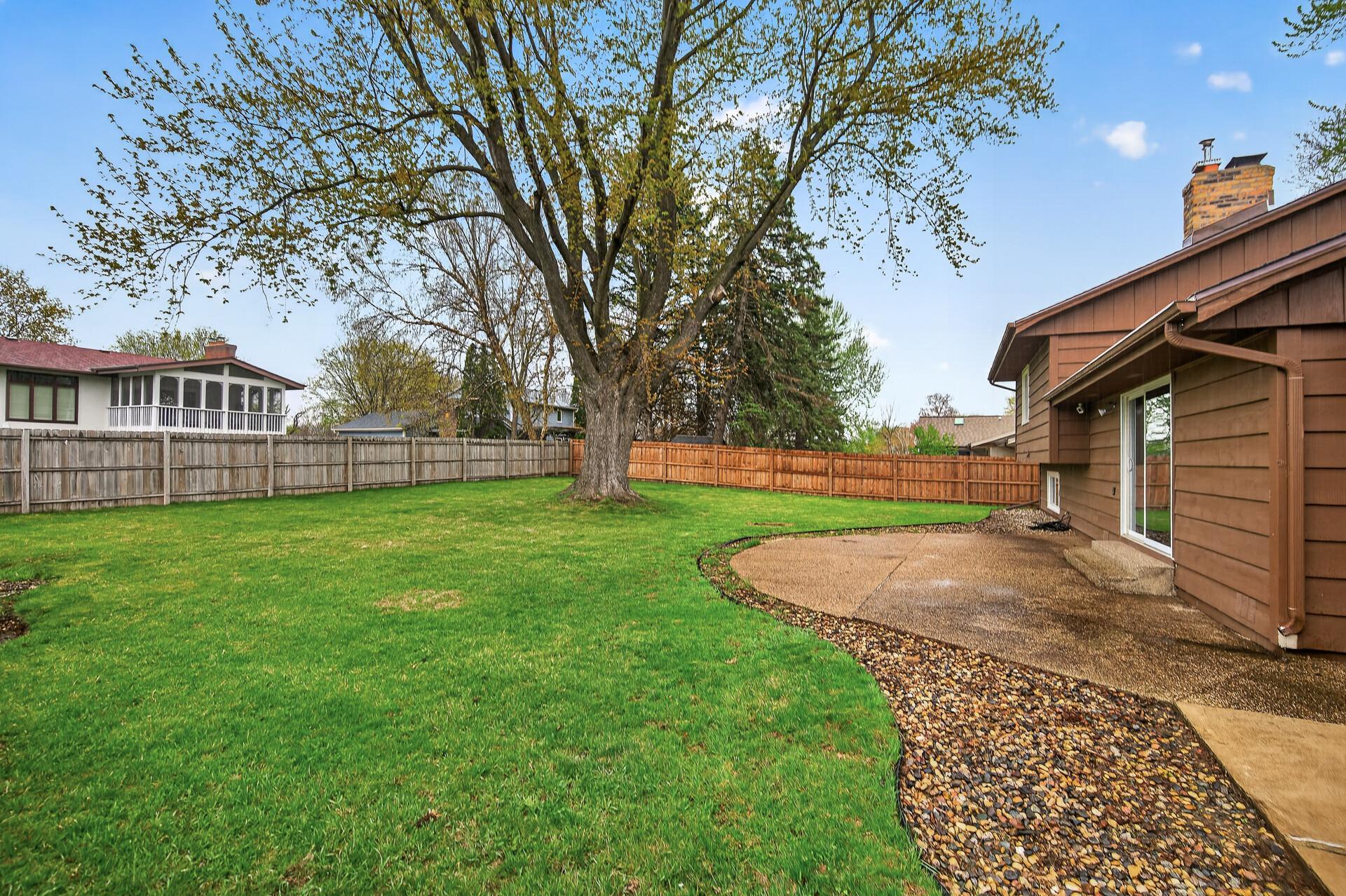The property boasts a large, flat, fully fenced backyard with a spacious patio, ideal for entertaining