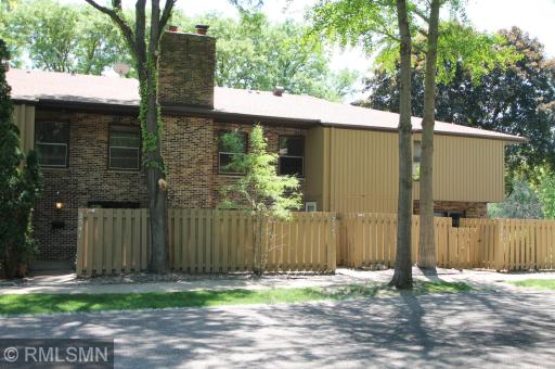 A warm and inviting brick and wood exterior welcomes you home.