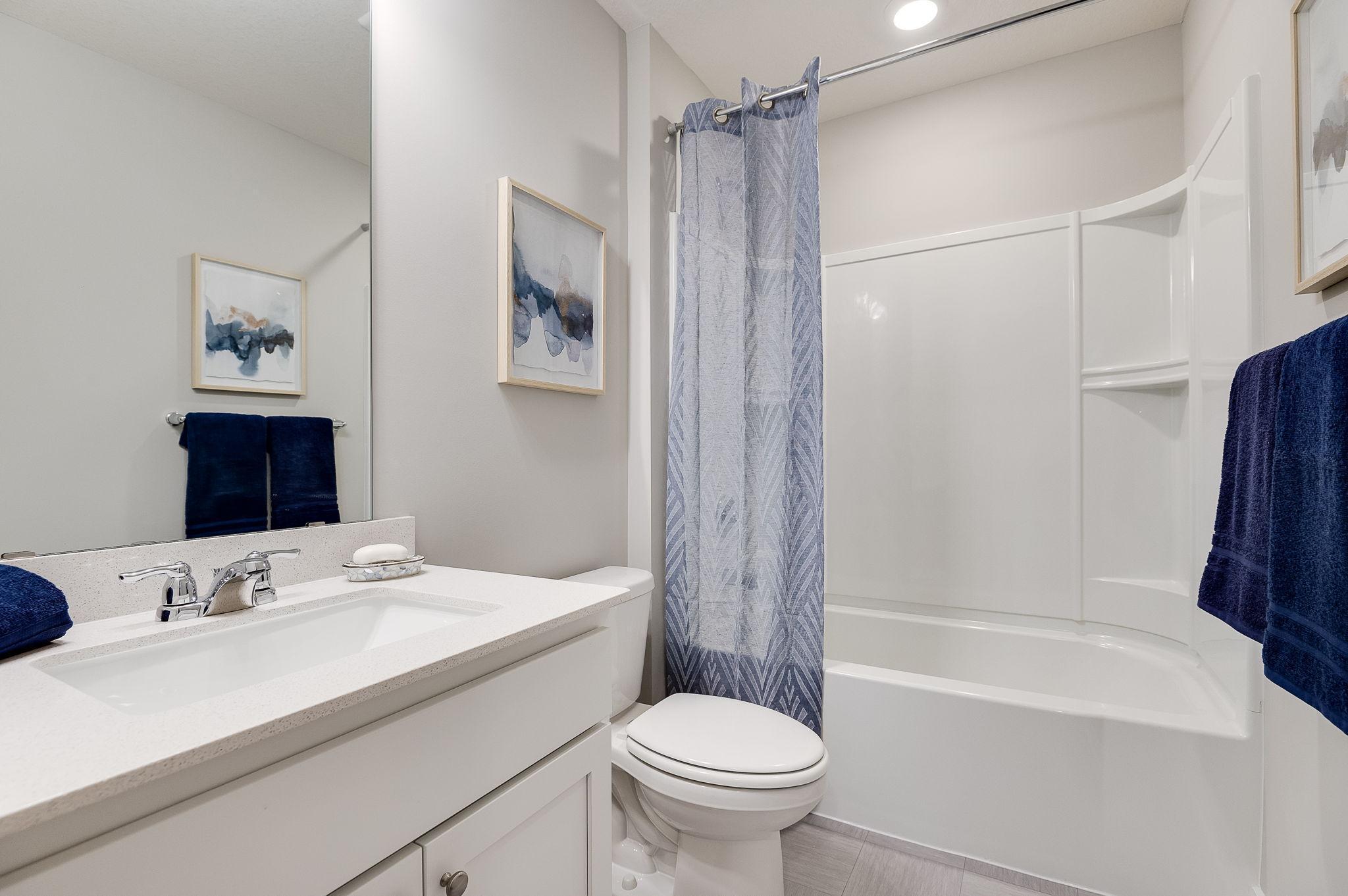 The lower level bathroom is complete with a tub, shower, toilet and spacious sink!