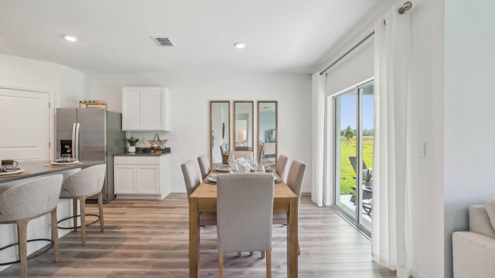 Sliding door from dining space will take you to a covered deck, included with the home!