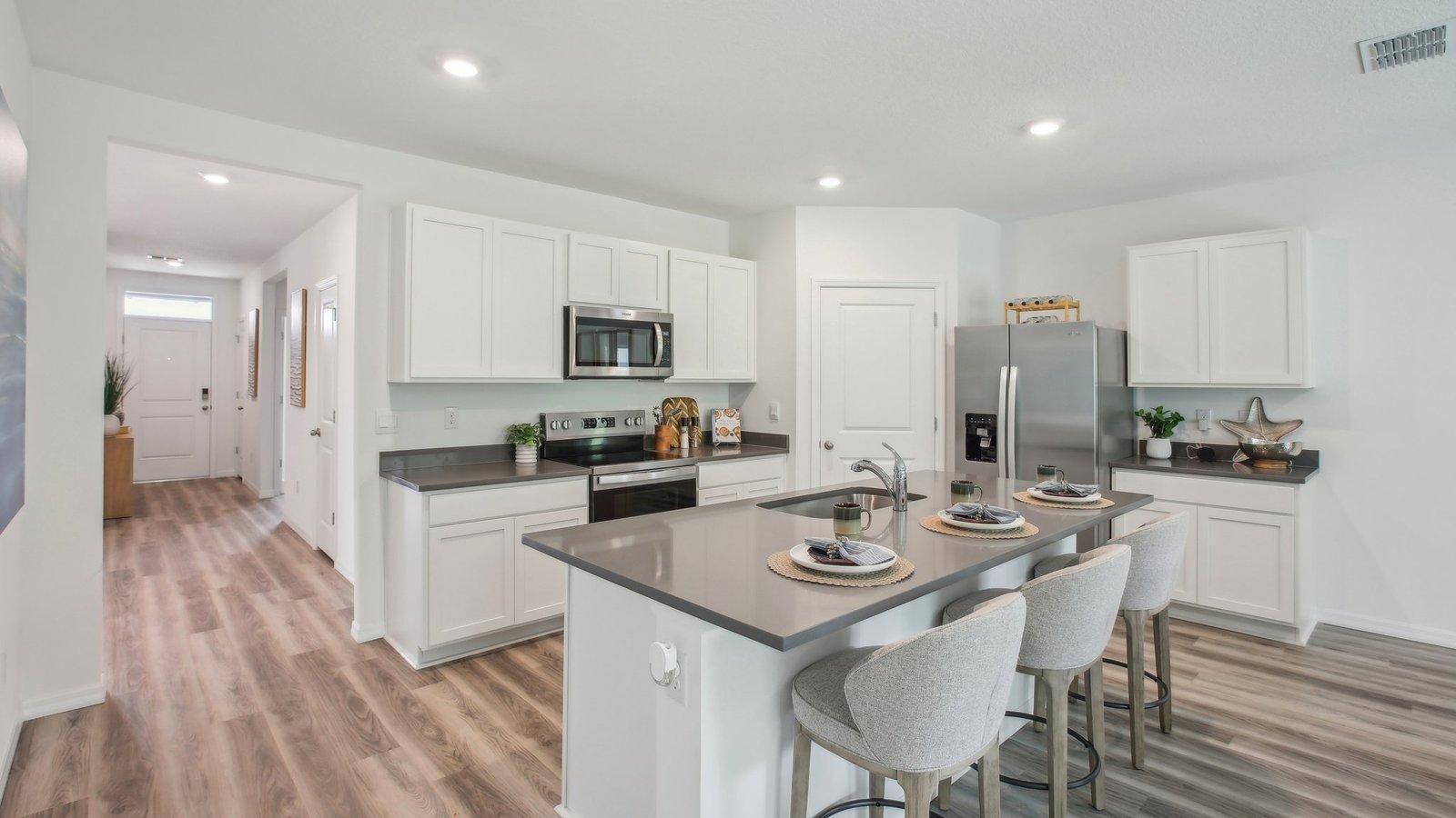 The Cali offers a spacious kitchen with island for seating. Actual home will include a gourmet kitchen with kitchen aid appliances and hood, vented to the outside.