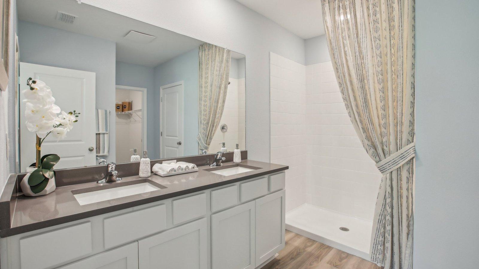 Main level primary suite bath with dual vanity.