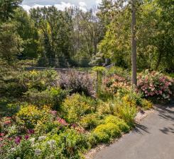 Check the supplements for a list of perennials that enhance this beautiful lot. In the backdrop is the 10' fenced tennis/ sport court.