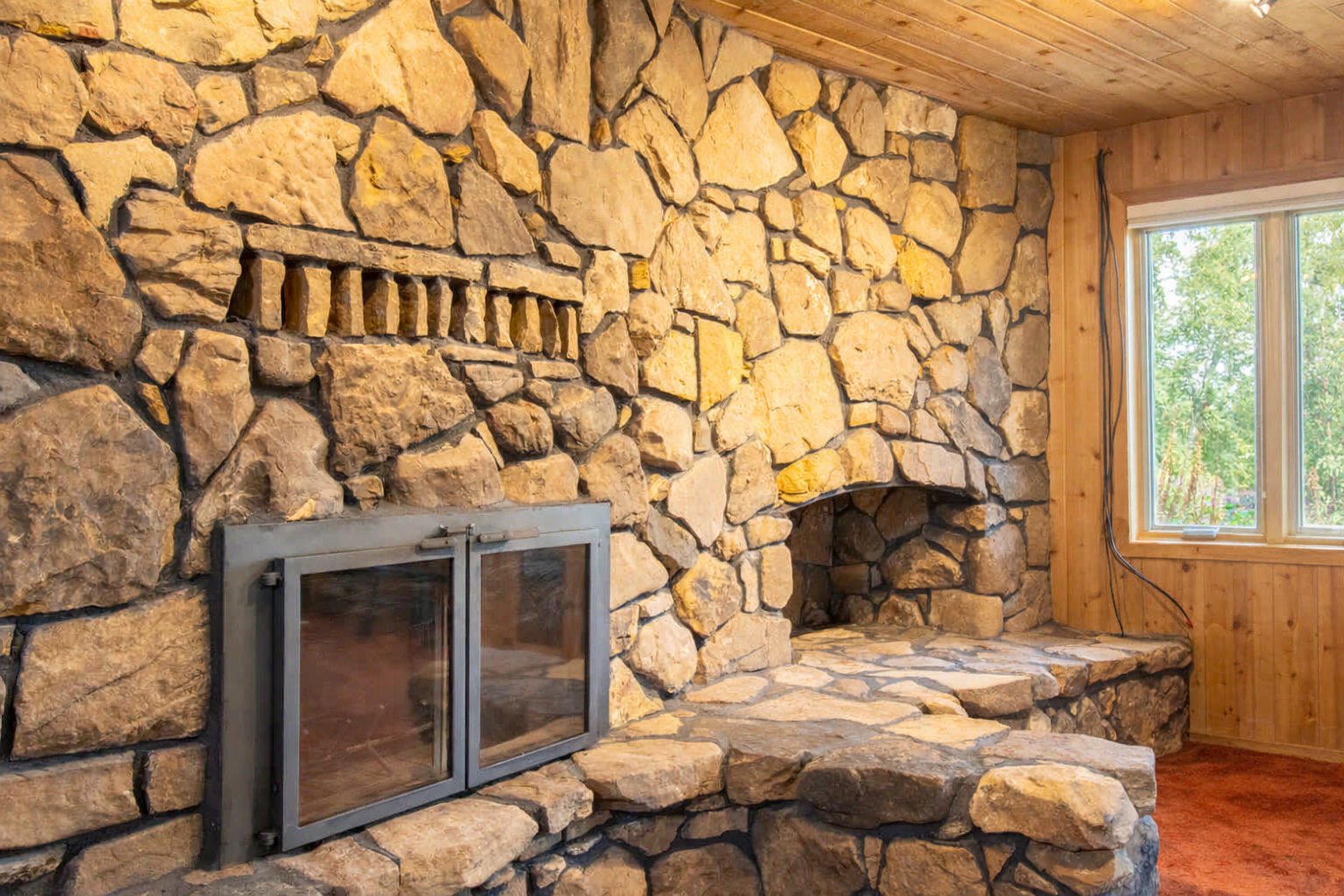 See-through, upper and lower-level monumental stone fireplaces, visible from all the main living areas, add to this homes stately interior.