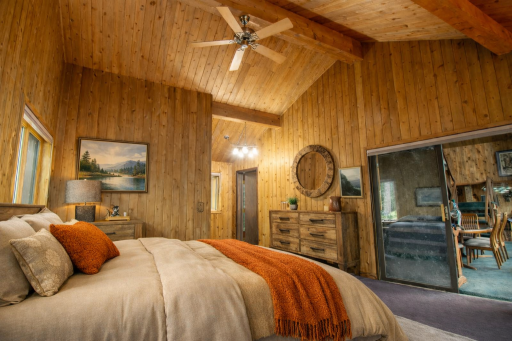 Spacious owners suite fells large featuring windows with virtually staged furniture.