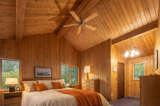 Owners suite features vaulted ceilings, a private balcony to overlook the lake, walk in cedar closet and a full spacious bath with dual vanity. The furniture in this phot is virtually staged.