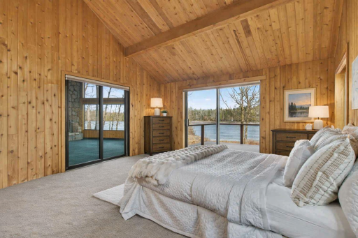 Owners suite features a private balcony . This photo depicts what the room would appear like with a neutral carpet color.