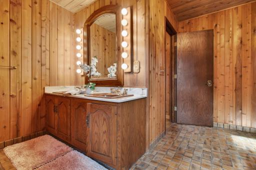 Second view of the main floor full bathroom featuring a dual vanity.