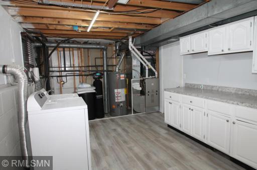 The laundry room has a sink next to the washing machine and extra cabinetry and counterspace - a nice and convenient work area with lots of storage. The furnace, water heater and water softener are all newer.