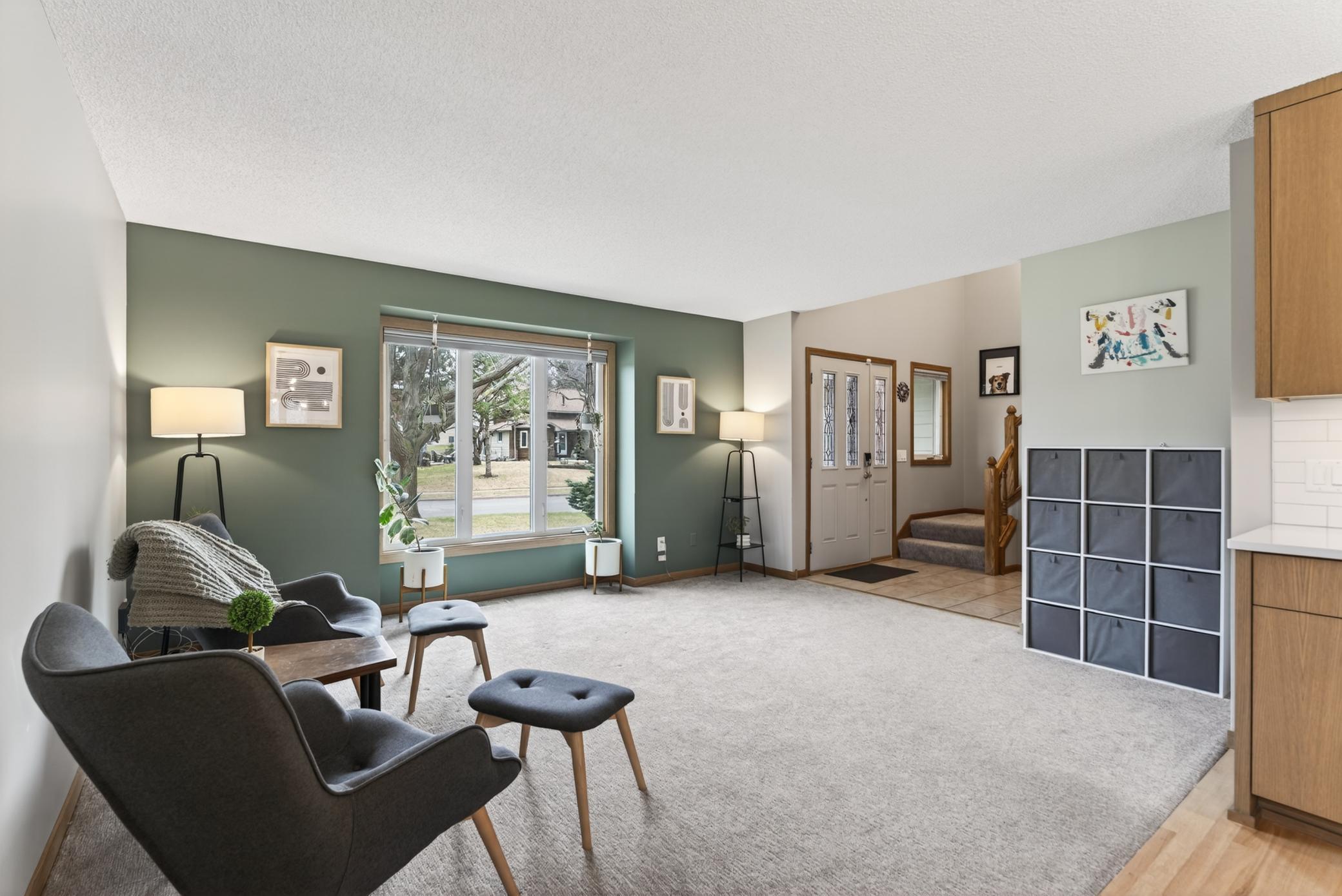 Living room features fresh paint and new carpet.